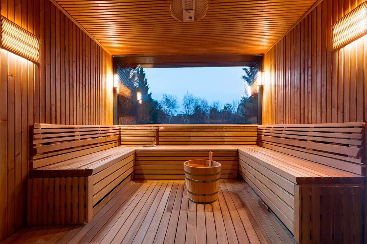 top sauna installation ideas for home - gorgeous sauna with benches and window - All Pros Property Services